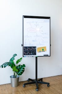 Whiteboard with cryptocurrency concepts and charts in a modern office.
